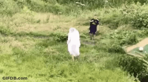 Woman In White Dress Running Through Grassy Field GIF