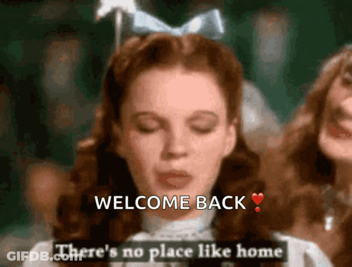 Woman In White Dress Saying Welcome Back GIF