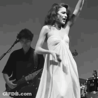 Woman In White Dress Singing While Man Plays Guitar GIF