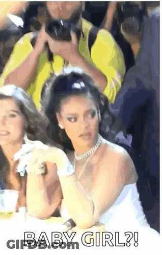 Woman In White Dress Sitting Among Crowd GIF