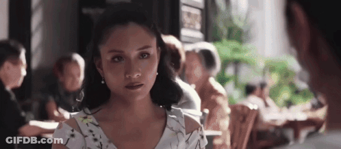 Woman In White Dress Sitting At Restaurant Table GIF