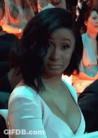 Woman In White Dress Sitting In Crowd GIF