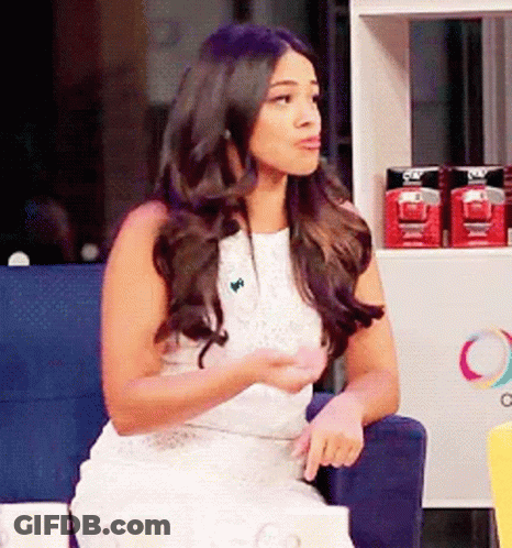 Woman In White Dress Sitting In Front Of Olay Shelf GIF