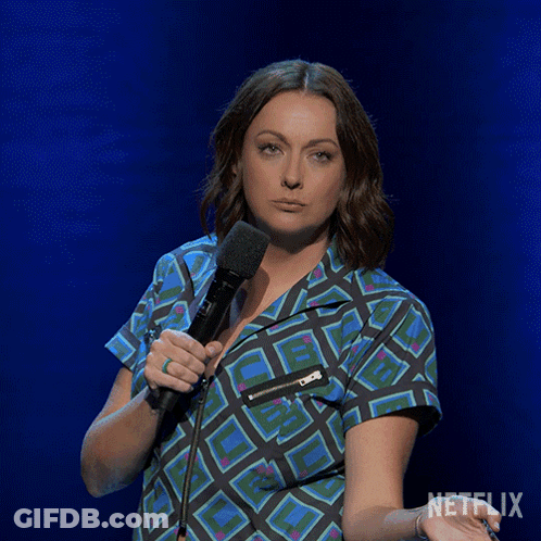 Woman In White Dress Sitting In Front Of Olay Shelf GIF