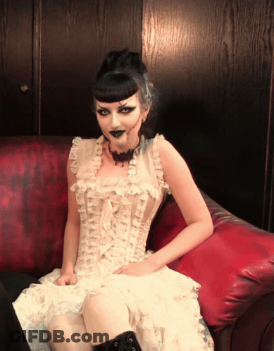 Woman In White Dress Sitting On Couch GIF