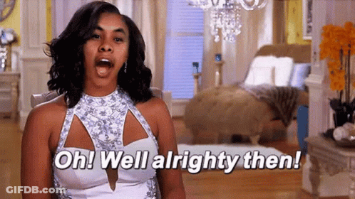 Woman In White Dress Sitting With Mouth Open GIF
