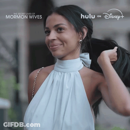 Woman In White Dress Smiling For Secret Lives Of Mormon Wives On Hulu GIF