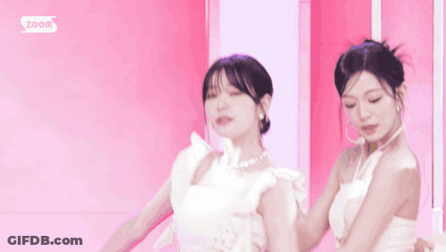 Woman In White Dress Smiling Next To Two Women GIF