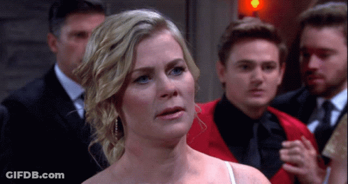 Woman In White Dress Standing Before Men GIF