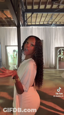 Woman In White Dress Standing By White Curtain GIF