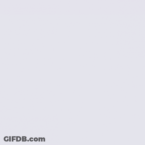 Woman In White Dress Standing In Front Of Stone Wall With Hands In Air GIF
