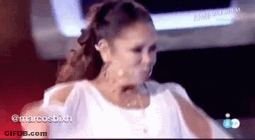 Woman In White Dress Standing In Front Of TV GIF