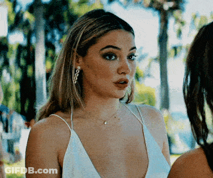 Woman In White Dress Standing Next To Another Woman GIF