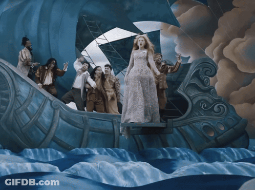 Woman In White Dress Standing On Boat In Ocean GIF