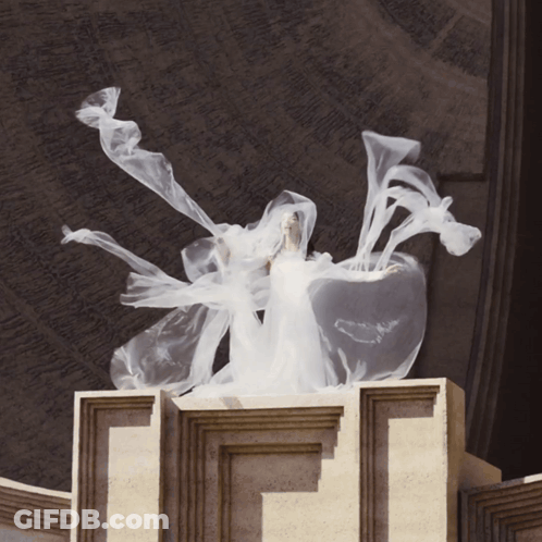 Woman In White Dress Standing On Pillar GIF