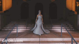 Woman In White Dress Standing On Stairs GIF