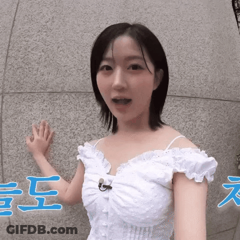 Woman In White Dress Talking Into Microphone GIF