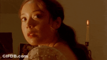Woman In White Dress Tying Ribbon In Hair GIF