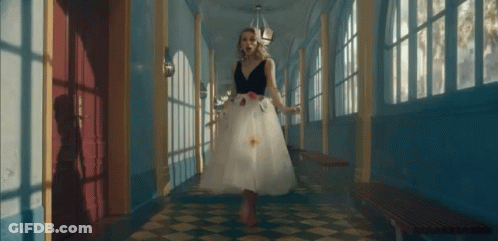 Woman In White Dress Walking Checkered Floor Hallway GIF