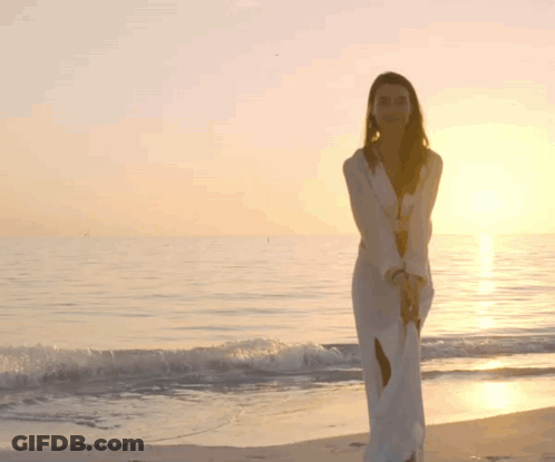 Woman In White Dress Walking On Beach GIF