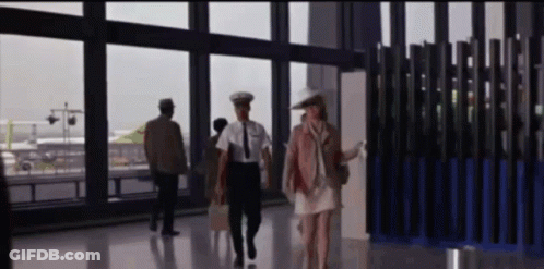 Woman In White Dress Walking With Man In Uniform GIF