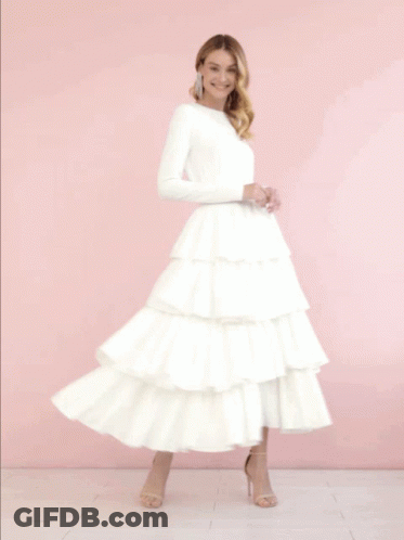 Woman In White Dress With Ruffled Skirt GIF