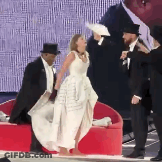 Woman In White Dress With Tuxedo Men And Hats GIF
