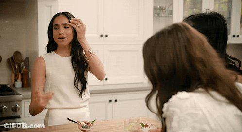 Woman In White Dress With Two Women In Kitchen GIF