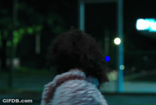 Woman In White Fur Coat Blue Sign A GIF
