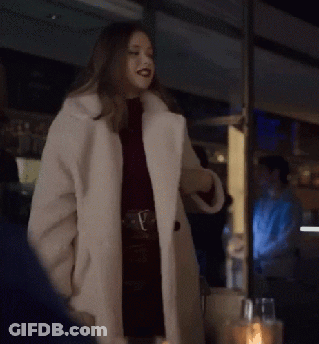 Woman In White Fur Coat By Window GIF