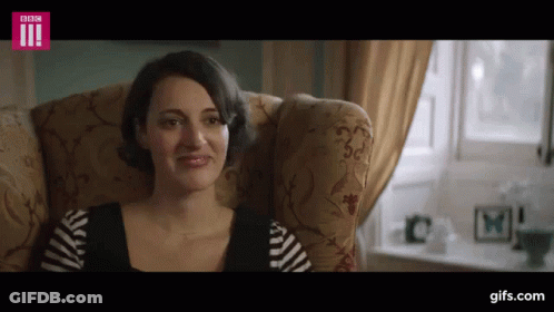 Woman In White Garrett Top Holding Hair GIF