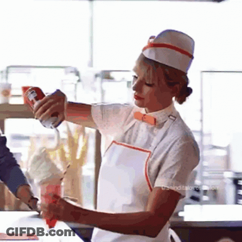 Woman In White Hat And Apron Pouring Whipped Cream Into Cup GIF