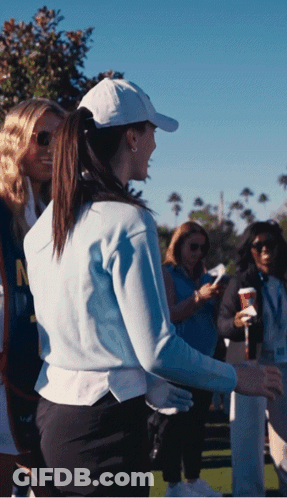 Woman In White Hat And Blue Sweater With Letter N GIF