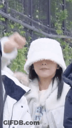 Woman In White Hat And White Jacket Standing Next To Man GIF