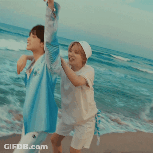 Woman In White Hat Carrying Woman On Beach GIF