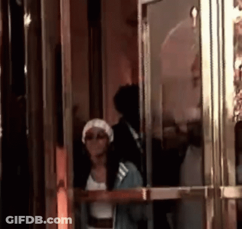 Woman In White Hat Standing In Doorway GIF