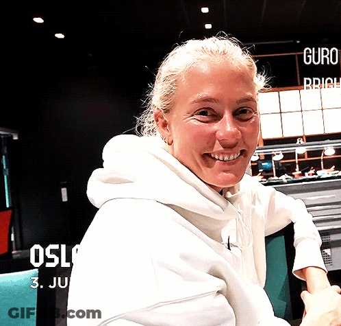 Woman In White Hoodie Smiling At Oslo Sign GIF