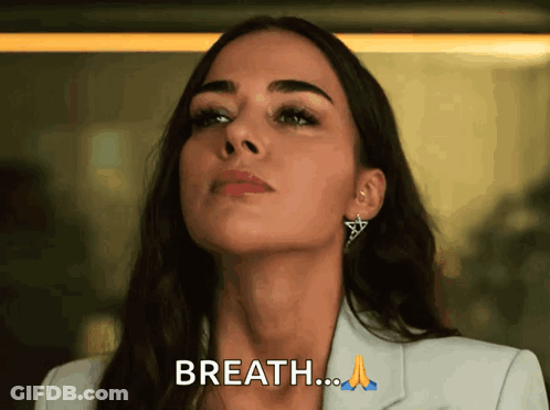 Woman In White Jacket And Earrings Saying Breath GIF