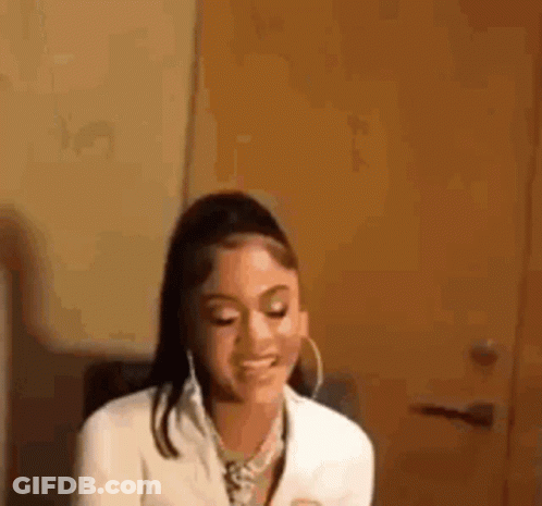 Woman In White Jacket And Hoop Earrings Smiling GIF
