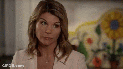 Woman In White Jacket And Necklace Looking Away GIF