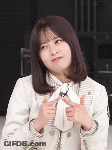 Woman In White Jacket And Tie Making Face GIF