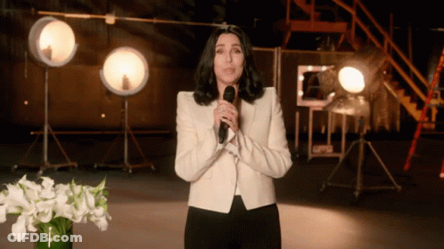 Woman In White Jacket At Microphone GIF