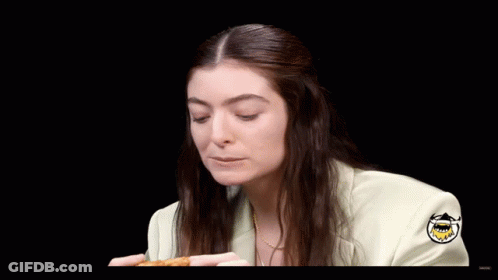 Woman In White Jacket Eating Pizza Saying Delicious Wang GIF