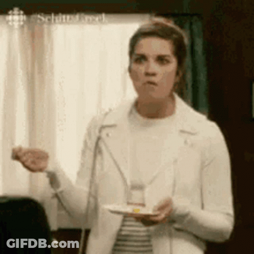 Woman In White Jacket Holding Plate Of Food GIF