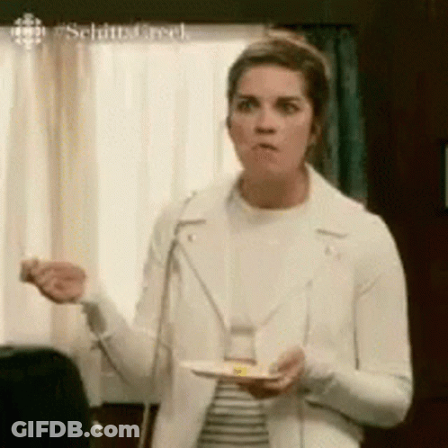 Woman In White Jacket Holding Plate Of Food GIF