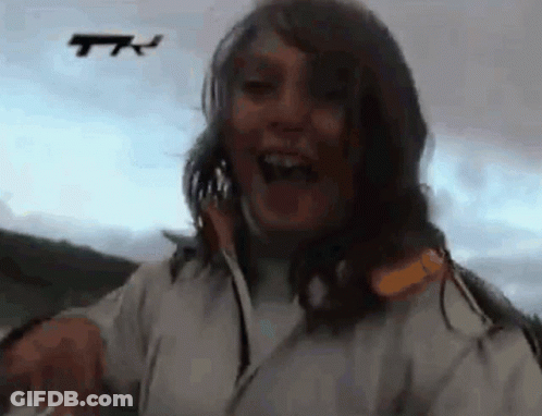 Woman In White Jacket Laughing At Drone GIF