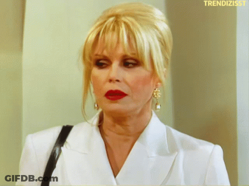 Woman In White Jacket Red Lipstick Saying Trendizisst GIF
