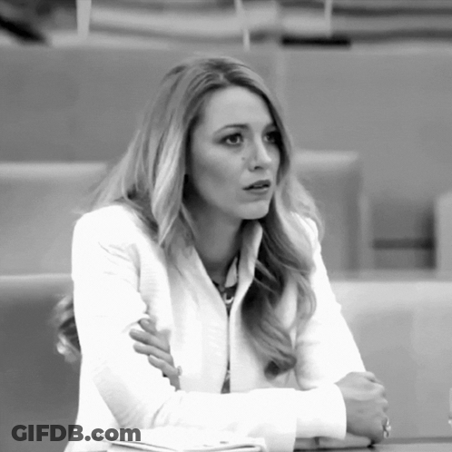 Woman In White Jacket Sitting Crossed Arms GIF