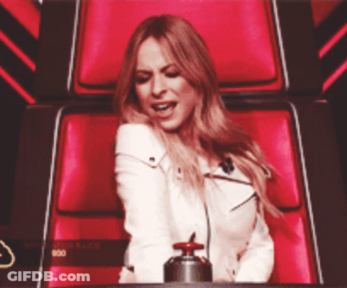 Woman In White Jacket Sitting In Red Chair GIF