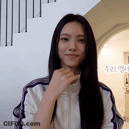 Woman In White Jacket With Purple Stripes Smiling GIF
